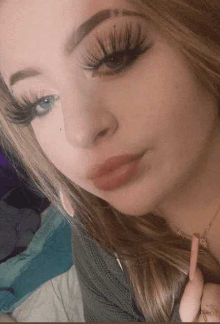 a close up of a woman with long eyelashes