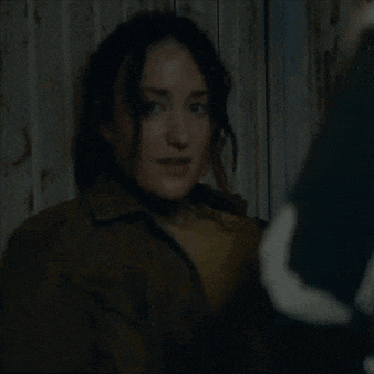 a woman with a surprised look on her face is talking to a man