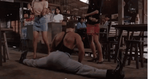 a group of people are dancing in a room with a sign for pepsi on the wall