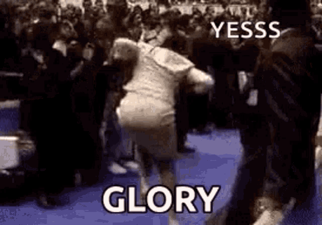 a woman is dancing in front of a crowd with the words `` glory '' written on the bottom .