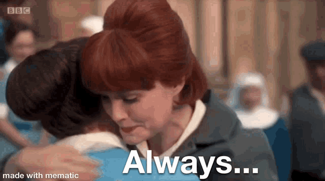 a woman with red hair is hugging another woman in a crowded room .