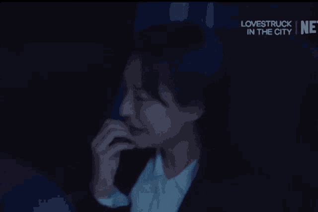 a woman is crying in a dark room with lovestruck in the city written on the bottom
