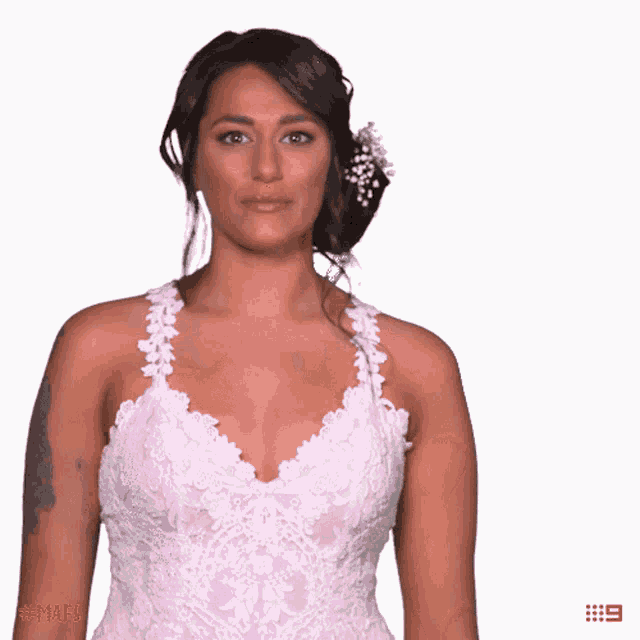 a woman in a wedding dress with the number 9 on the bottom right