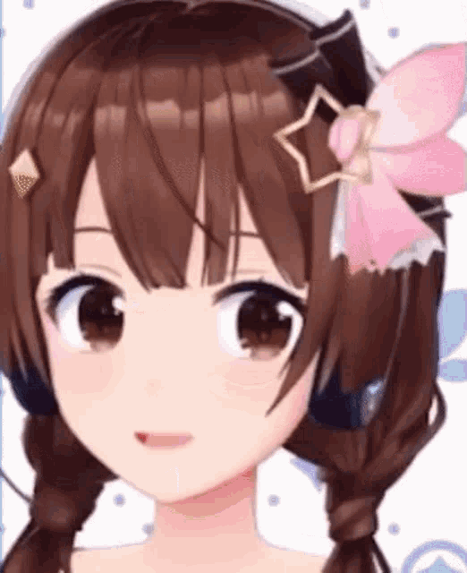 a close up of a girl 's face with a pink bow on her head .