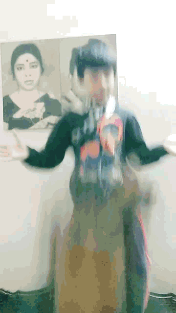 a blurry picture of a person with their arms outstretched in front of a picture of a woman