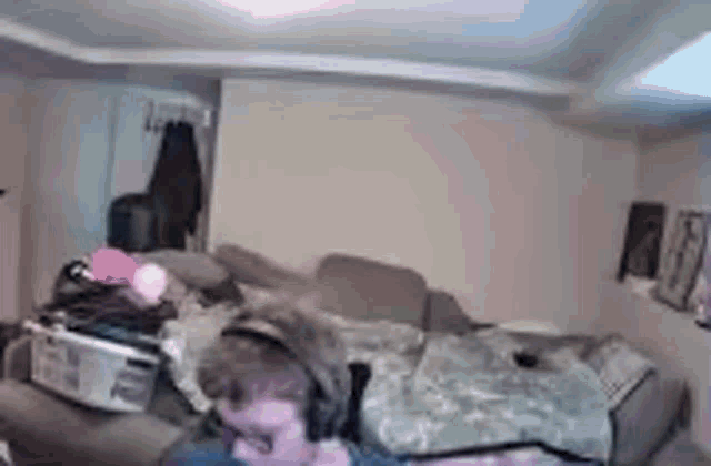 a messy room with a couch and a bed