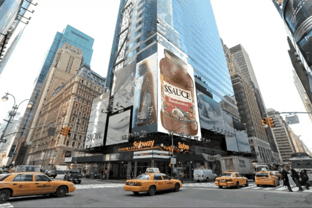 a busy city street with a billboard for ssauce