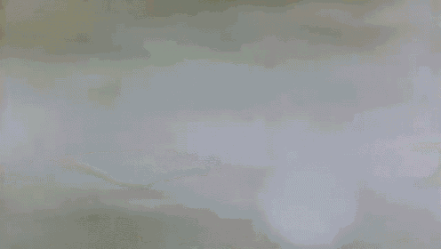 a close up of a cloudy sky with a white circle in the middle of it .