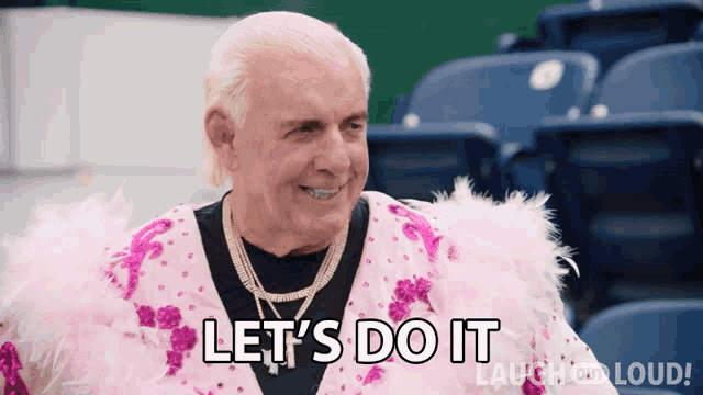 a man in a pink feathered outfit is saying let 's do it