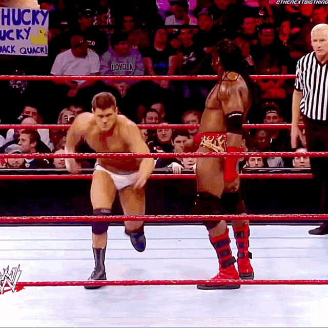 a wrestler in a ring with a sign that says husky lucky