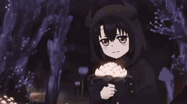 a little girl in a black hoodie is holding a lotus flower in her hands in a dark forest .