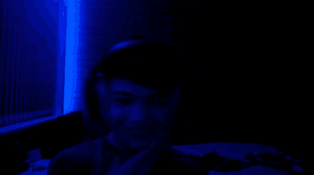 a person wearing headphones in a dark room