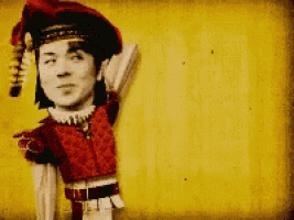 a black and white photo of a man in a jester outfit