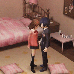 a boy and a girl are kissing in a bedroom with pink pillows