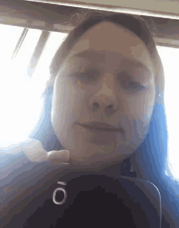 a woman is taking a picture of herself with a phone that has the letter o on it