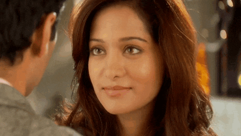 a man and a woman are looking into each other 's eyes