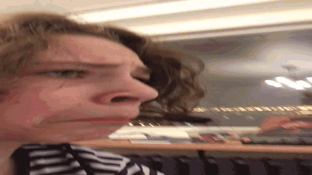 a blurry picture of a person 's face with a striped shirt on