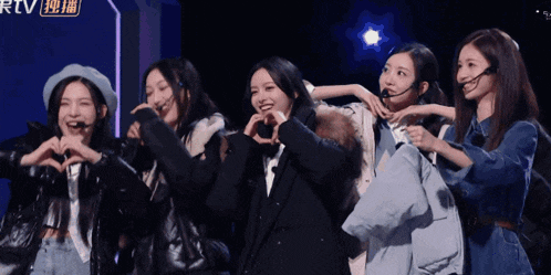 a group of young women are making hearts with their hands in front of a sign that says rtv