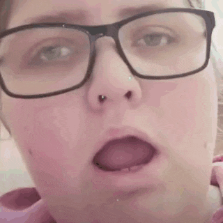 a close up of a woman wearing glasses with the words burps cutely