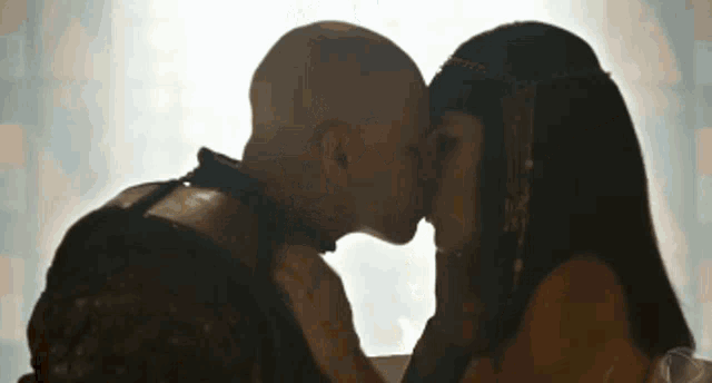 a man and a woman are kissing each other