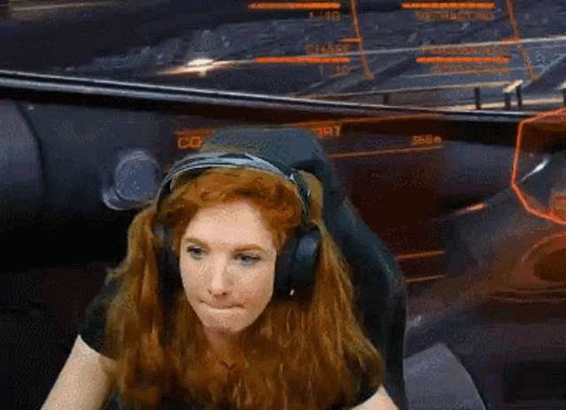 a woman wearing headphones is sitting in front of a screen that says ' flight ' on it
