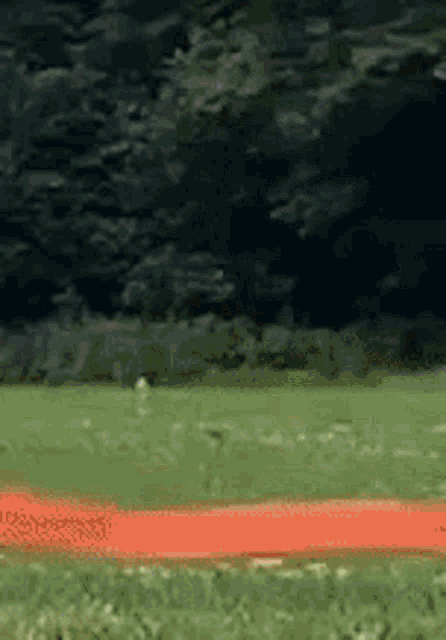 a person is running on a track in a field .