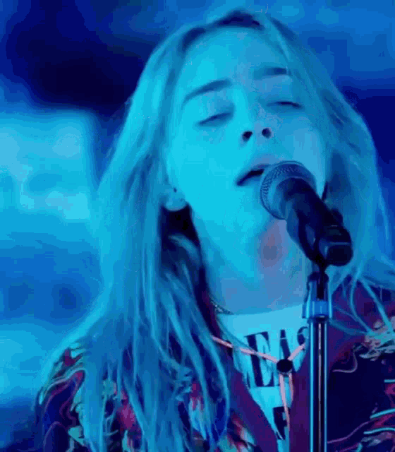 a close up of a woman singing into a microphone .