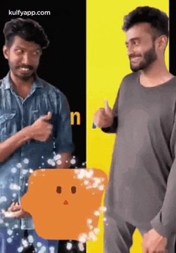 two men are standing next to each other and one of them is holding an orange object .