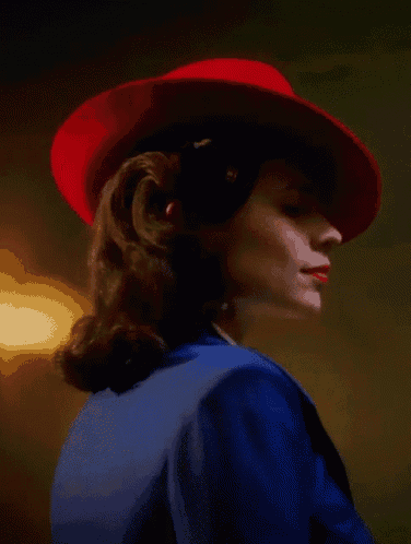 a woman wearing a red hat and blue jacket