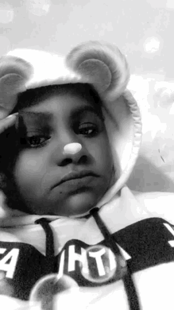 a black and white photo of a person wearing a hoodie that says " a hot "