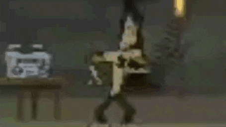 a cartoon character is sitting on a table with a hand on his chest .