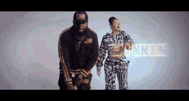a man and a woman are dancing in front of a sign that says " bounce "