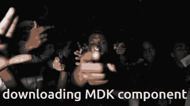 a man pointing a gun at a crowd with the words downloading mdk component above him