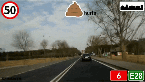 a car is driving down a road with a sign that says 6 e28 on it