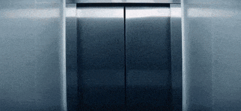 a stainless steel elevator door is open and empty