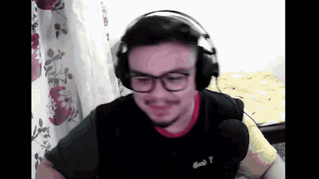 a man wearing headphones and a shirt that says lacoste