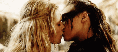 a close up of two women kissing each other .