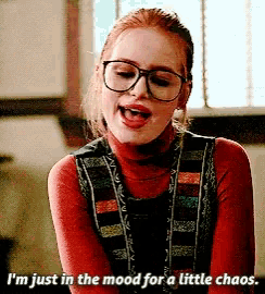 a woman wearing glasses and a turtleneck sweater says i 'm just in the mood for a little chaos
