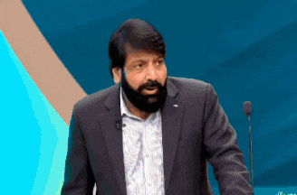 a man with a beard is giving a speech