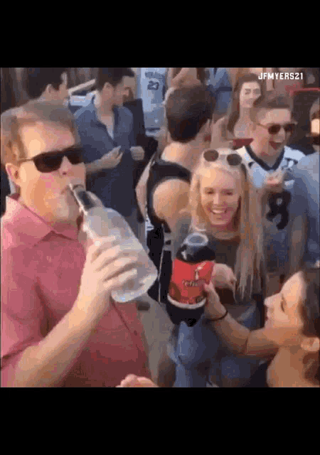 a man drinking from a straw while a woman holds a coke