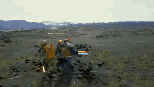 a video game is being played on a computer and a robot is fighting another robot in the desert .