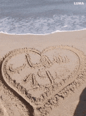 the word daddy is written in the sand