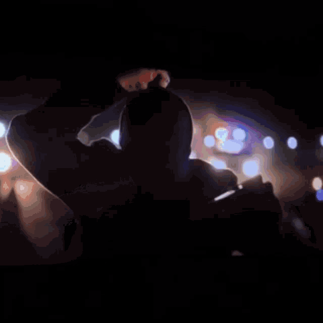 a close up of a man 's face with a blurry background of lights