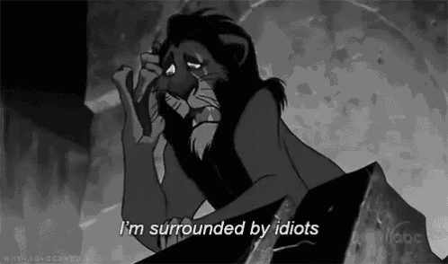 a black and white photo of a lion with the words i 'm surrounded by idiots
