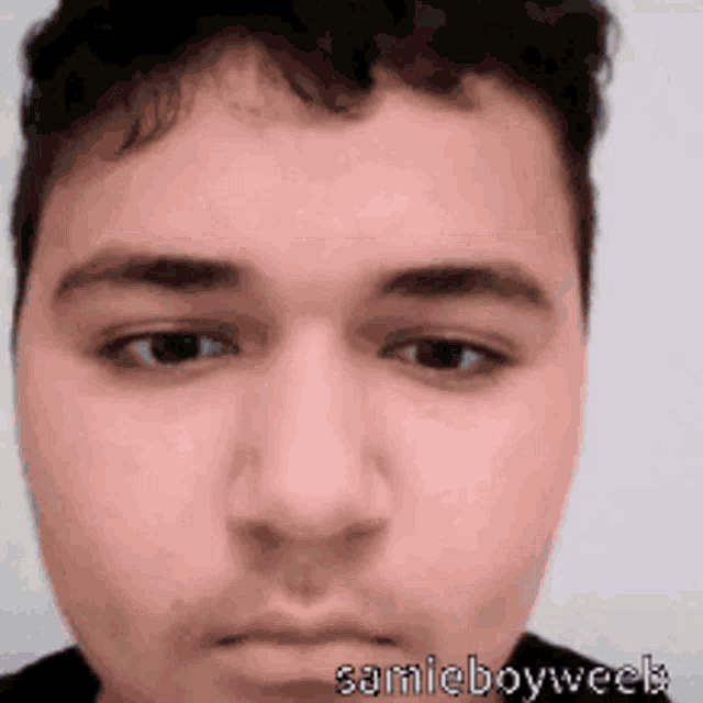 a close up of a man 's face with the name samicboyweek written below it