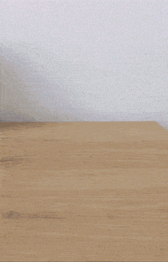 a stuffed doll is sitting on a wooden floor