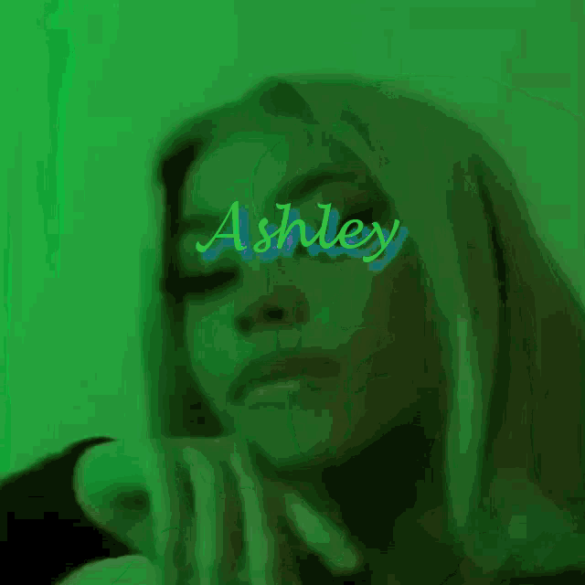 a close up of a woman 's face with the name ashley written on it .