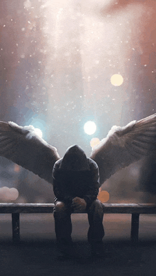 a man in a hoodie with angel wings is sitting on a bench
