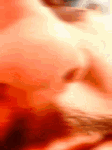 a blurry picture of a person 's face with a red and yellow background