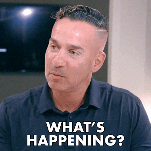 a man in a blue shirt says what 's happening in white letters